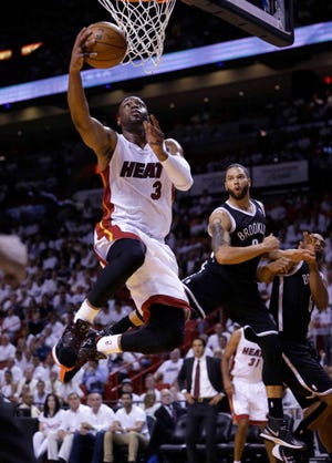 Miami Heat guard Dwyane Wade (3) goes to th basket against the Brooklyn Nets during the first half of Game 5 of a second-round NBA playoff basketball game in Miami, Wednesday, May 14, 2014. (AP Photo)