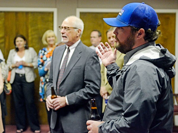 Jason Wilson, CEO of Back Forty Beer Co., right, speaks as Gordon Linkous, director of manufacturing at Goodyear-Gadsden, looks on, at a reception Wednesday at The Chamber in celebration of their respective companies winning the Alabama Manufacturer of the Year competition in their divisions.