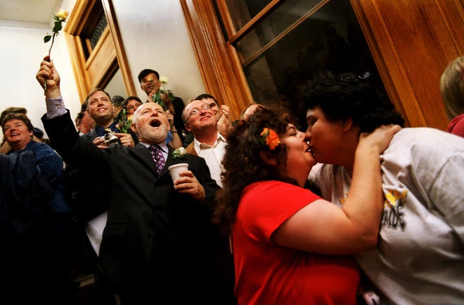 Jean Vierira, left, and Rhonda Hicks celebrate the stroke of midnight on May 17, 2004, when the city of Cambridge issued the first same-sex marriage license in the country. Wicked Local file photo/Winslow Martin