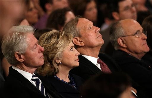 From left, Former U.S. President Bill Clinton sits with his wife former U.S. Secretary of State Hillary Clinton, former New York Governor George Pataki and former New York City Mayor Rudolph Giuliani during the dedication ceremony at the National September 11 Memorial Museum in New York, Thursday, May 15, 2014. (AP Photo/Mike Segar, Pool)