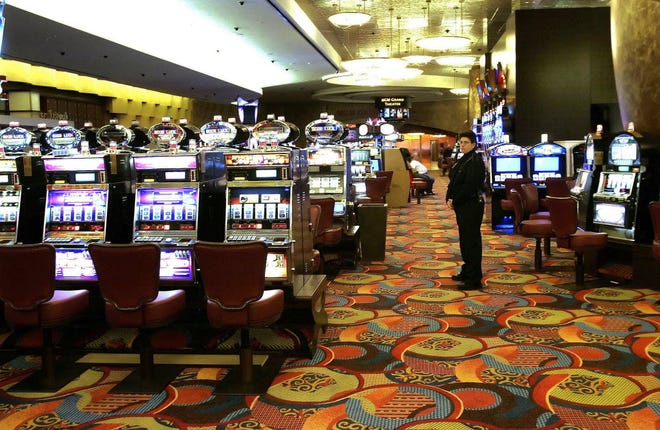 In this May 13, 2008 file photo, one of the slot machine rooms at the MGM Grand Hotel stands ready for the start of business at the Foxwoods Resort Casino in Mashantucket, Conn.
