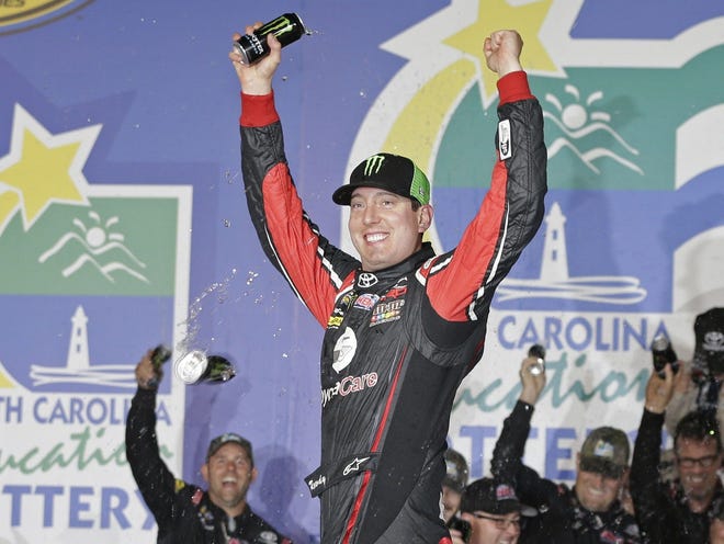 Kyle Busch celebrates in Victory Lane after winning the NASCAR Trucks Series race Friday at Charlotte Motor Speedway in Concord, N.C.