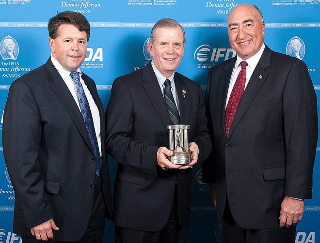 Rep. Tim Walberg was presented an IFDA Thomas Jefferson Award by Tom Zatina (right), president of McLane Foodservice, and Barry Bates (left), senior manager of Broadline Distribution for Gordon Food Service. COURTESY PHOTO