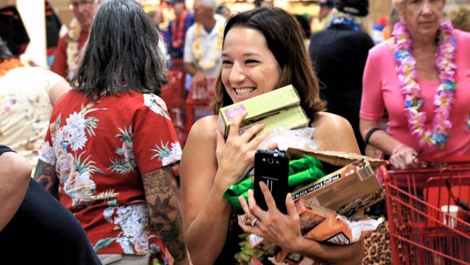 Neila Weber stocks up during the grand opening of the new Trader Joe's in Wellington Friday morning. (Lannis Waters/The Palm Beach Post)