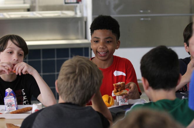 Ayden Monteiro has lunch with his friends in the cafeteria at Little Compton's only school. At left is Noah Goldman.