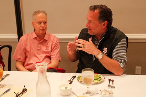 North Carolina State basketball coach Mike Gottfried, right, talks with Wolfpack supporter Bobby Purcell during the area Wolfpack Club banquet Thursday night at the Jacksonville Country Club.