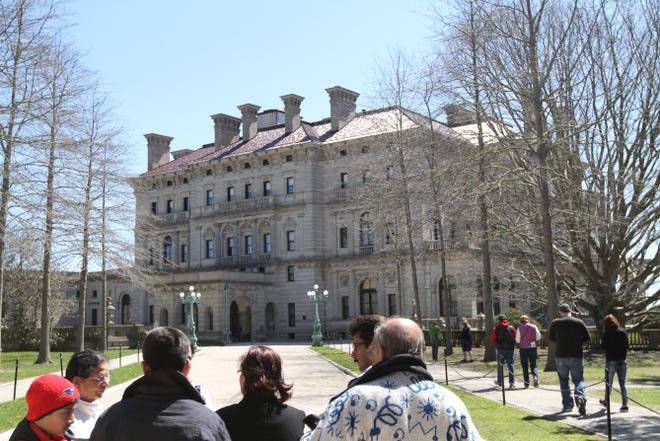 Tourists stream through the gates at The Breakers in Newport, the most popular of the Preservation Society of Newport County's 10 properties. Keeping these prized properties maintained takes a small army and a lot of money.
