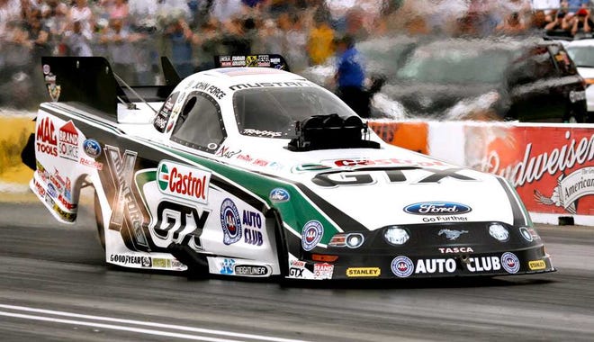 Funny Car driver John Force makes his record-breaking run at the NHRA Kansas Nationals in May, 2013 at Heartland Park. Force broke the Heartland Park track record on his first run of the day with a time of 4.043 at 313.22 mph.