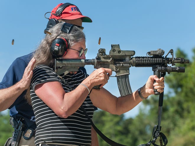 Shells fly as News-Journal police reporter Lyda Longa fires an M4 rifle during Friday’s session at the FBI Citizens Academy in Daytona Beach.