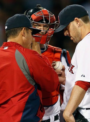 Red Sox pitcher John Lackey, right, chats it up with pitching coach Juan Nieves, left, and catcher A.J. Pierzynski in the fifth inning of Saturday night’s game against the Tigers at Fenway Park.