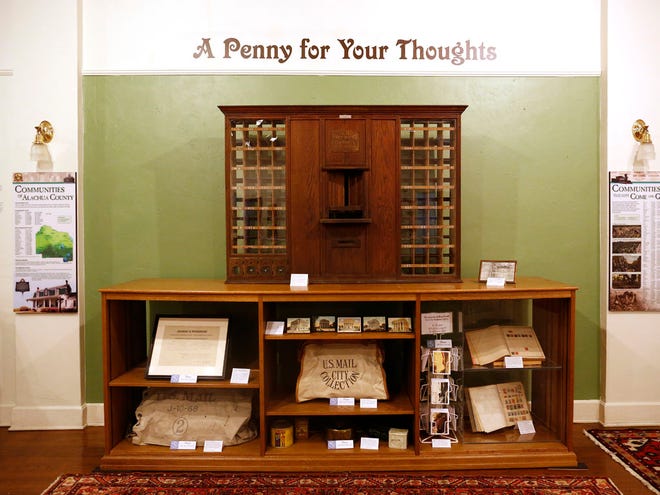 The Matheson Museum's new exhibit, "A Penny for Your Thoughts," highlights the museum's collection of more than 20,000 postcards from every Florida county, including Alachua and Marion. The exhibit includes this 1915 wooden post office cabinet front.