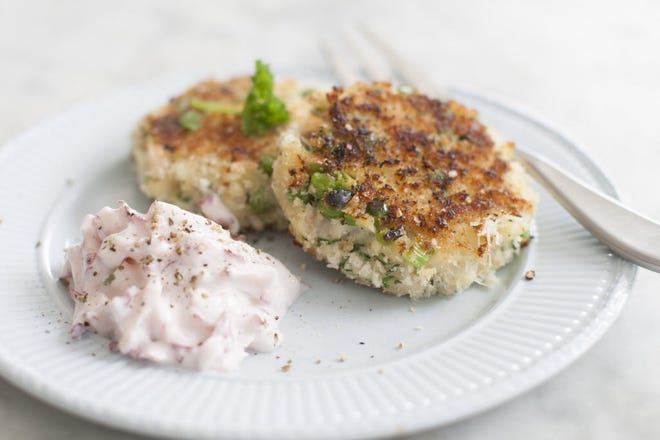 The crab cakes are topped off with a peppery cream flavored by both horseradish and red radishes.