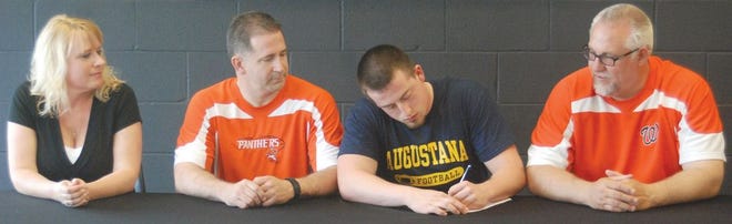 Washington Community High School senior Colton Marshall, second from right, signed May 7 with Augustana College, where he will play football for the Vikings. With Marshall in the Torry Gymnasium foyer were, from left: his mother Shelly Marshall, father Curtis Marshall and WCHS football head coach Darrell Crouch.