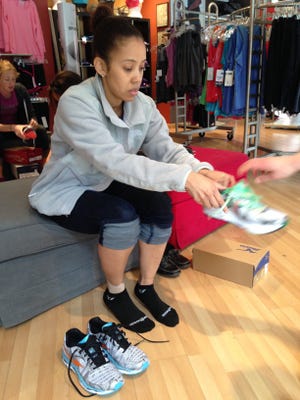 Danielle Tolbert tries on a pair of running shoes in Philadelphia on April 25.