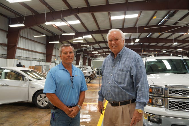 Tony Gayne, service director, and Glenn Ritchey, president and CEO of the Ritchey Automotive Group, stand inside the new facilities for Jon Hall Body Shop, which opened Monday.