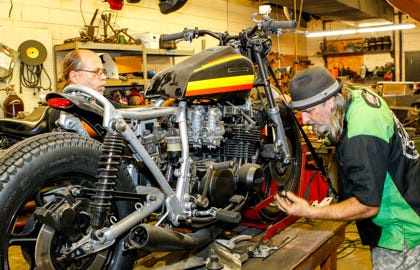 JDN051614_BikeBuilders  Dave Zabroski, the Combat Cycles head technician, and owner Joe Moran rebuild a motorcycle in the back shop on Friday.