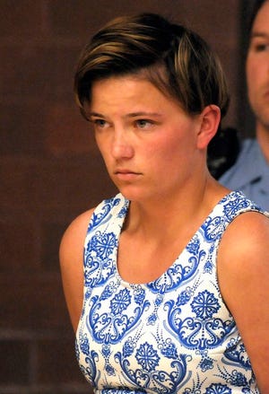 Danielle Shea, 22, of Quincy, Mass., stands as she is charged with threatening in the first degree for a bomb threat at Meriden Superior Court in Meriden, Conn., Monday May 19, 2014. Shea, while trying to keep her family from learning she had dropped out of college, called in bomb threats to the commencement ceremony at Quinnipiac University this past weekend, according to police.