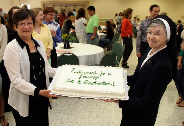JAMIE MITCHELL • TIMES RECORD / Immaculate Conception Catholic School teachers Janet Smith, left, and Sister Mary Sarto have their picture made with their retirement cake Sunday during a reception in the IC Parish Hall. Smith has been a teacher at the private Catholic school for 42 years, and Sister Mary Sarto is retiring after 35 years at the school.