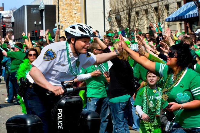 In this Journal Star file photo from 21011, Peoria Police Chief Steve Settingsgaard, rides a Segway and high-fives parade-goers during the St. Patrick's Day Parade in Downtown Peoria.