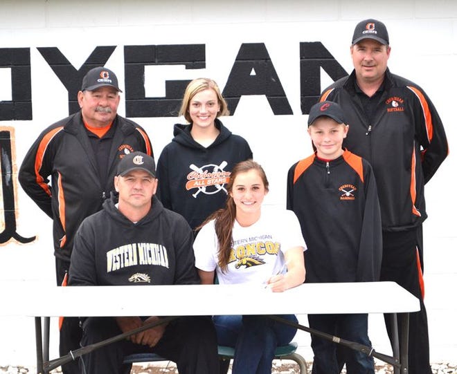 In the fall of 2013, Cheboygan senior Aspen Williams, seated next to her father, Joe Williams, signed her National Letter of Intent to play college softball at Western Michigan University. Also pictured in the back row from left are Cheboygan assistant coach Mike LaLonde, teammate and cousin Bridget Blaskowski, brother Caleb Williams, and Cheboygan head coach Mike LaLonde. Not pictured in the photo are her mother, Sheila Williams, and brother Cole Williams, who currently plays for the Cheboygan varsity baseball team.