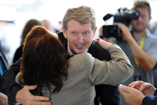 Newly-elected NASCAR Hall of Fame driver Bill Elliott receives a hug as he makes his way through the crowd at the Hall of Fame after a news conference announcing the 2015 class inductees on Wednesday, May 21, 2014, in Charlotte, N.C. The class features Elliott, Wendell Scott, Joe Weatherly, Rex White, and Fred Lorenzen. (David T. Foster, III/Charlotte Observer/MCT)