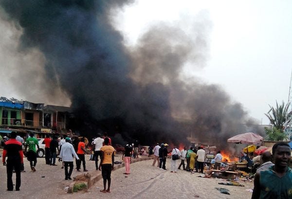 Smoke rises after a bomb blast at a bus terminal in Jos, Nigeria, Tuesday, May 20, 2014. Two explosions ripped through a bustling bus terminal and market frequented by thousands of people in Nigeria's central city of Jos on Tuesday afternoon, and police said there are an unknown number of casualties. The blasts could be heard miles away and clouds of black smoke rose above the city as firefighters and rescue workers struggled to reach the area as thousands of people fled. THE ASSOCIATED PRESS