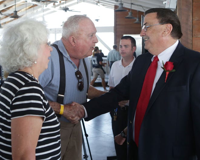 Alice and Gene Hedges greet Joe Moore during Moore's retirement party at Bud and Alley's on Wednesday in Panama City Beach. "We've watched him every day, me for 10 years and Gene for 30 years," Alice said. "He's part of our lives."