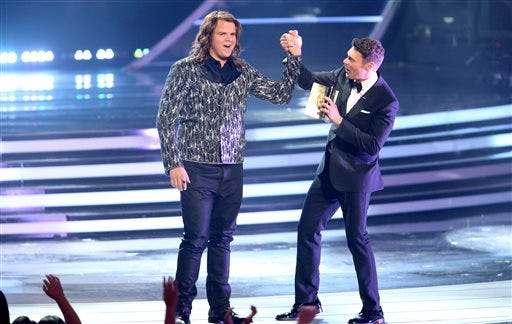 Ryan Seacrest, right, announces Caleb Johnson the winner at the American Idol XIII finale at the Nokia Theatre at L.A. Live on Wednesday, May 21, 2014, in Los Angeles.