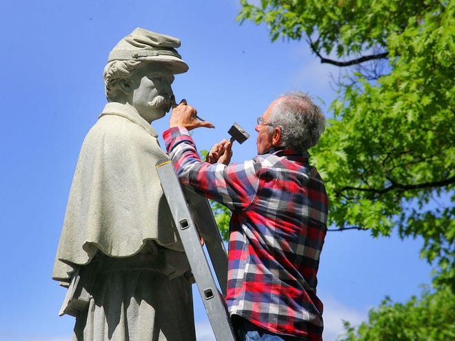 n preparation for Memorial Day, stone sculptor Miroslav Maler, of New York City, makes detailed restorations to the 1874 Civil War monument outside Braintree Town Hall, Tuesday, May 20, 2014.The monument, made of Quincy granite, was fully cleaned last year and final restorations were made to the 140-year-old monument,