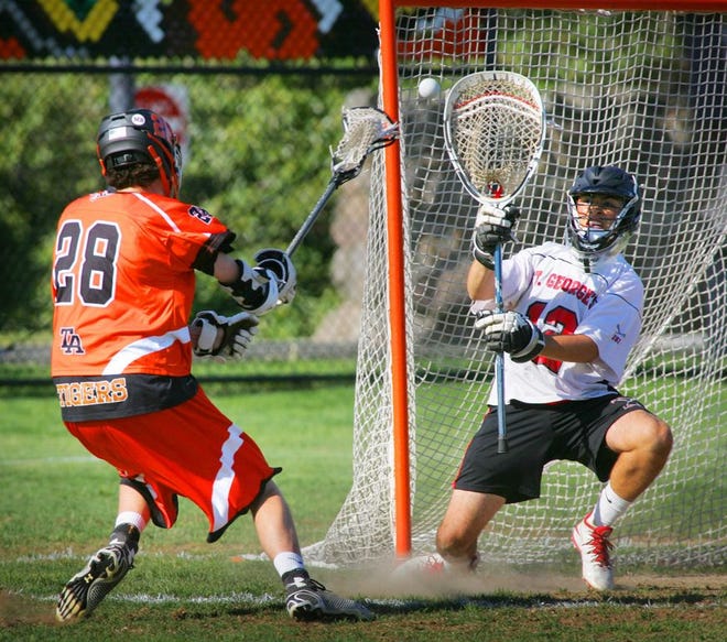 A shot by Thayer's Austin Lyne is blocked by St. George's Jonathan Tesoro. Thayer Academy hosted St. George's School in high school lacrosse Wednesday, May 21, 2014.