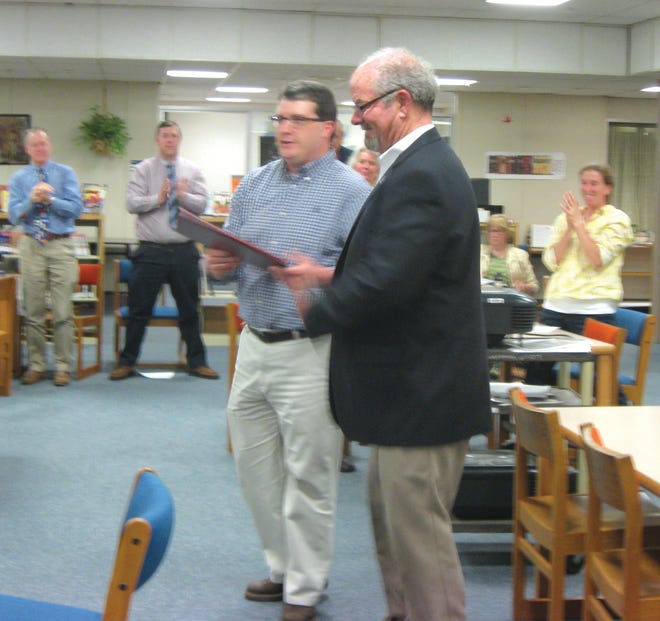 State Rep. Paul McGowan, D-York, presents York High School teacher Jeff Barry with a Legislative Sentiment honoring Barry for his work with students on Project Citizen, during a faculty meeting Wednesday, May 21.
