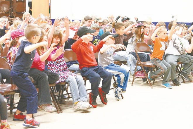 Mackinaw City students perfect their scary laughs at author Christopher Wright's presentation at the school Thursday. Wright, who writes the popular “Michigan Chillers,” books, encouraged students to read and write creatively.