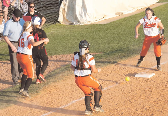 The ball comes loose after North Davidson third baseman Madison Everhart (16) tags Northwest Guilford's Hannah Richey. Charging toward the loose ball are North catcher Sierra Vanzant (15) and left fielder Maggie Fritts. Richey made it back to the bag but was then called out after straying off the bag.