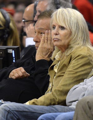 Los Angeles Clippers owner Donald Sterling, left, and his wife Shelly watch a 2012 playoff game in this file photo. Donald Sterling has agreed to surrender his stake of the Clippers to his wife, and she is moving forward with selling the team, a source told The Associated Press on Friday.
