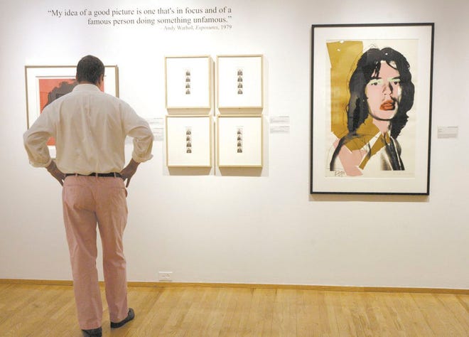 A visitor to the Massillon Museum takes in the artwork of Andy Warhol at the museum’s “Disco Ball” on June 22, 2013. The museum has displayed work from Warhol and Holocaust survivor Nelly Toll within the last year. Now, the museum is set to open an exhibit called “Fragile Waters,” which features 117 black-and-white photos from famed photographers Ansel Adams, Ernest H. Brooks II and Dorothy Kerper Monnelly.