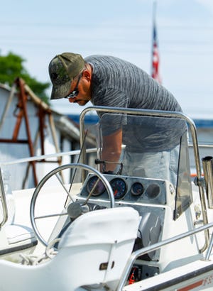 Dan Towning checks over some lines on his sailboat while docked at Casper’s Marina in Swansboro, Thursday morning before doing some sailing over the upcoming weekend. Photo by John Althouse/The Daily News