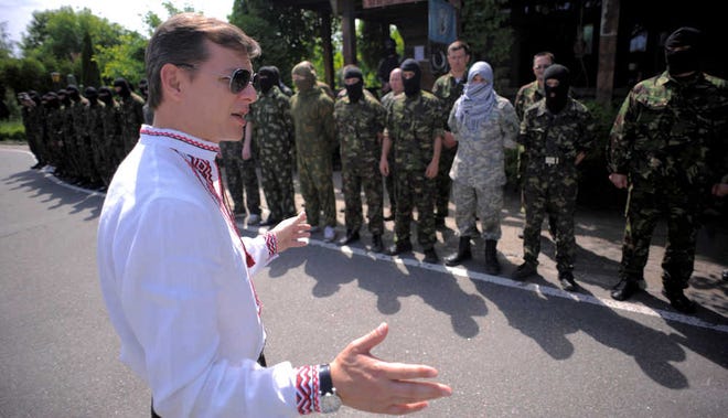 Osman Karimov/The Associated PressOleh Lyashko, left, leader of Ukrainian Radical Party and presidential candidate, speaks to self-defense volunteers on Friday at a training ground outside Kiev, Ukraine.