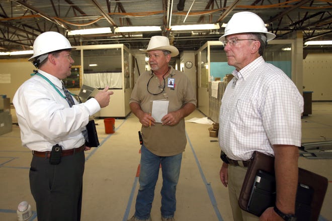 Robert Knight, the supervisor of facilities for Marion County Public Schools, left, talks with William Douglas, the construction superintendent for The Alexander Group, center, and Charles Gannaway, the contruction supervisor for Marion County Public Schools, right, in a classroom that is being renovated at East Marion Elementary School in Lynne, Fla. on Wednesday, May 14, 2014. Marion County Public Schools will be receiving maintenance funding for first time in three years. For the last three years, the district missed out on $4 million in state dollars when the State Legislature stopped funding the Public Education Capital Outlay program that school districts used to repair schools.