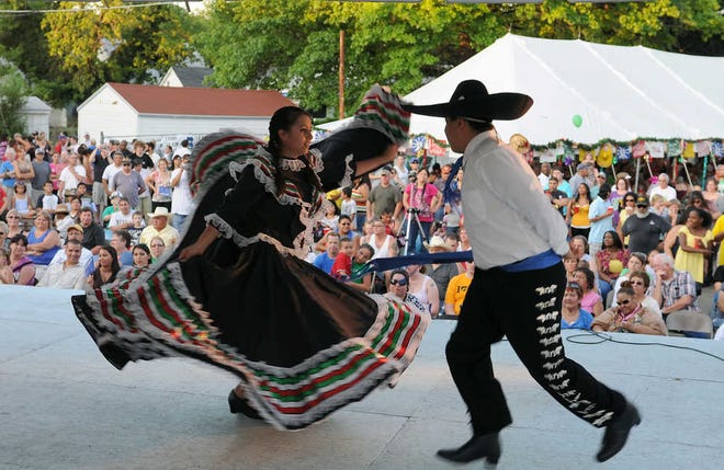 A large crowd watches the Our Lady of Guadalupe Dancers as they demonstrate a traditional Mexican dance at last year's Fiesta Mexicana. This year's celebration will be July 15-19.