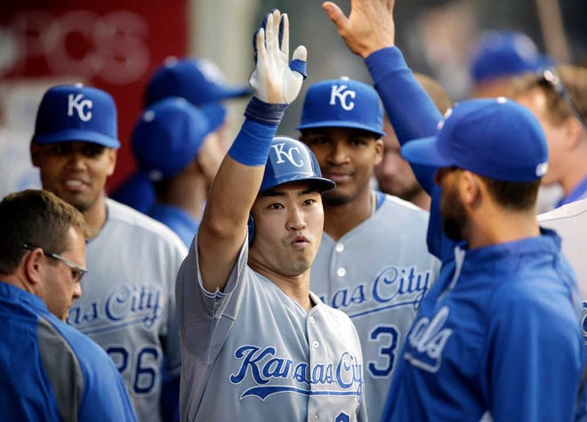 Kansas City Royals' Norichika Aoki, center, is greeted by teammates after he scored on an RBI single by Alex Gordon during the first inning against of a baseball game against the Los Angeles Angels on Friday night in Anaheim.