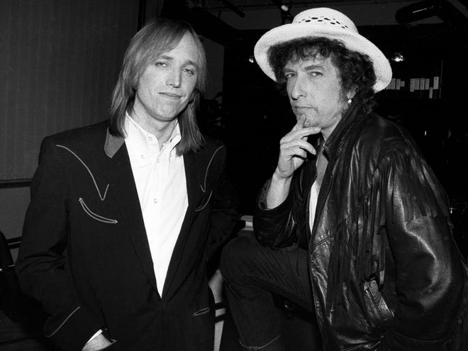 Singer/songwriters Bob Dylan, right, and Tom Petty are shown during a press conference in Los Angeles in April 1986, where they announced the continuation of their “True Confessions” concert tour.