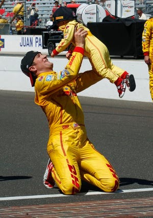 Ryan Hunter-Reay lifts his son, Ryden, after Hunter-Reay won the 98th running of the Indianapolis 500 IndyCar auto race at the Indianapolis Motor Speedway in Indianapolis, Sunday, May 25, 2014.