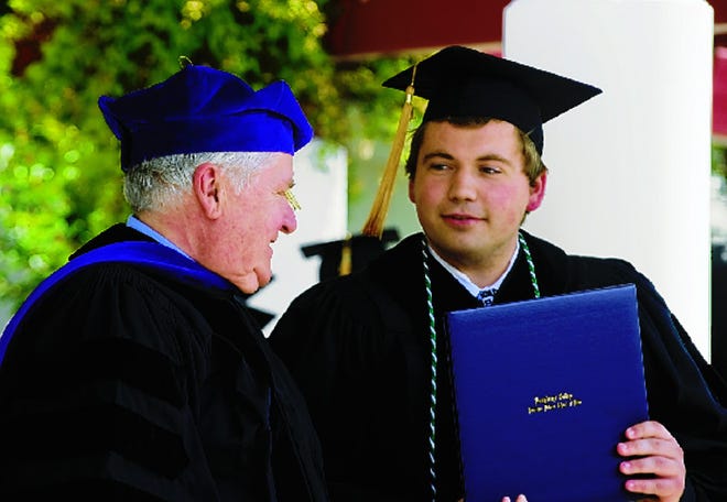 Dean of Law L. Patrick Piggott gives a diploma and congratulations to graduate Parker Shelton at the Laurence Drivon School of Law commencement ceremony Saturday at Humphreys College in Stockton.