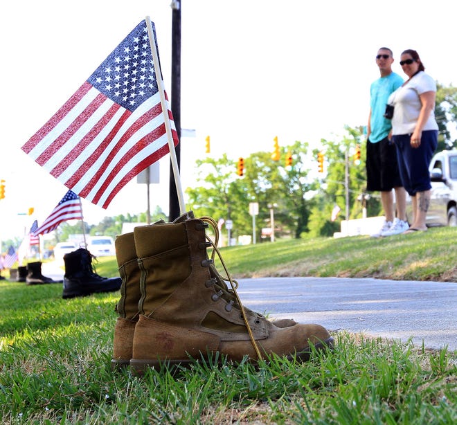 Stevie and Lisa Keen, from Havelock, look at the Salute the Boot memorial on Memorial Day on Monday at Havelock City Park. The couple just moved to Havelock in January. Stevie Keen is a corporal in the Marine Corps based at Cherry Point.