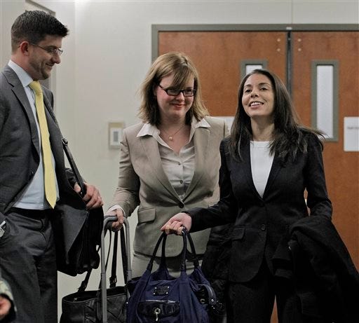 FILE- In this April 10, 2013 file photo, Fox television reporter Jana Winter, right, and her attorneys arrive at district court for a hearing for Aurora theater shooting suspect James Holmes in Centennial, Colo. The U.S. Supreme Court said Tuesday, May 27, 2014 that Winter does not have to reveal her confidential sources for a story about Holmes. (AP Photo/Ed Andrieski, File)
