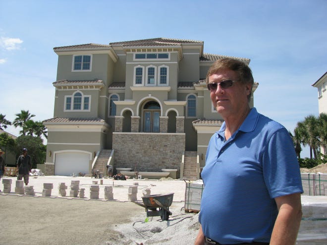 Dale Stevenson, president of Skyway Builders in Palm Coast, stands in front of a 6,500-square-foot custom luxury home his company is building in the gated Granada Estates section of the Hammock Dunes subdivision.