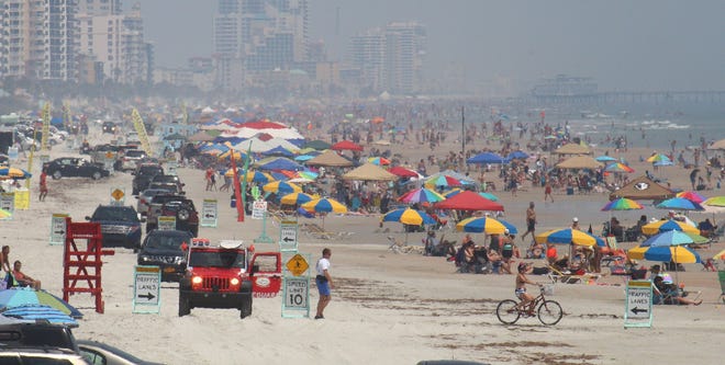 Looking north from the Sunglow Pier in Daytona Beach Shores shows thousands of people packed onto the Beach on a steamy Saturday. Local hoteliers say the throngs of beachgoers meant big business for them over the weekend — a good start to the busy summer travel season.