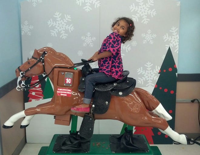 Kendalyn, 4, from Hubbardston, rides penny-pony Sandy after every trip to Meijer, her mom says. Kendalyn is in a commercial, debuting in June, promoting the retailer.