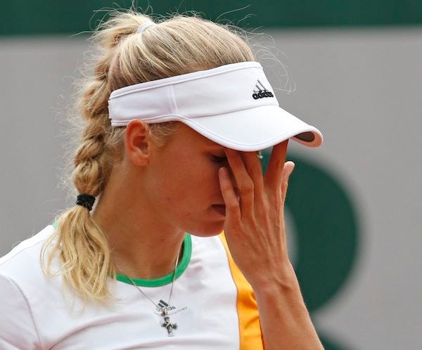 Denmark's Caroline Wozniacki wipes her face during the first round match of the French Open tennis tournament against Belgium's Yanina Wickmayer at the Roland Garros stadium, in Paris on Tuesday.