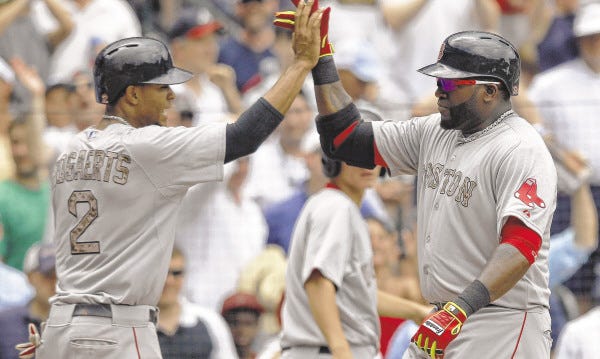 The Red Sox' David Ortiz celebrates with Xander Bogaerts after hitting a two-run homer during the fifth inning against the Atlanta Braves on Monday in Atlanta, Ga. Boston snapped a 10-game losing streak with an 8-6 win.